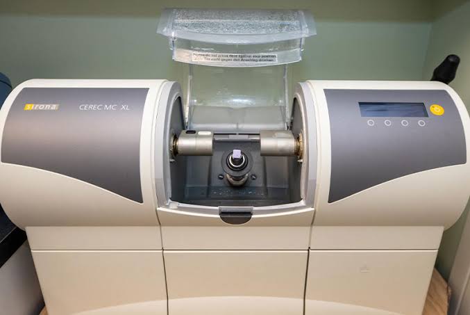 CEREC MC XL dental milling machine used to fabricate same-day dental restorations in a dental clinic.